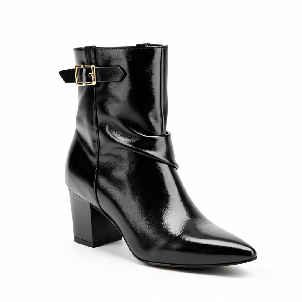 Black fold-over ankle boots with a gold-tone buckle
